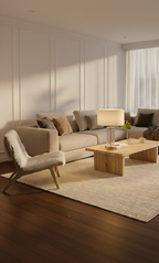 Modern living room with a beige sectional sofa, wooden coffee table, and armchair.