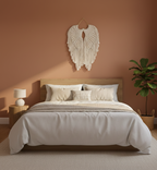 Neatly made bed with pillows and a decorative wall hanging in a bedroom setting.