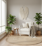 Cozy living room with a white armchair, round jute rug, and decorative wall art.