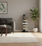 Modern living room with a gray sofa, bookshelf, and plant.