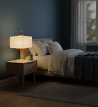 Bedroom with a bed, nightstand, and lamp under soft lighting.
