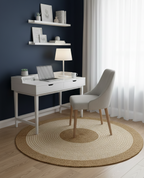 Modern home office with white desk, chair, and shelves against a dark blue wall.